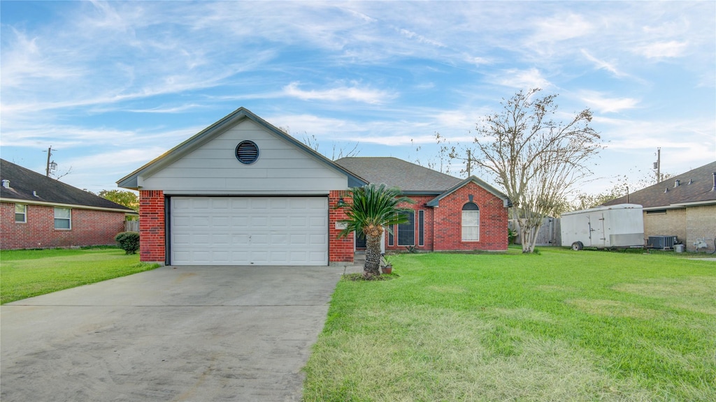 ranch-style house with a front yard, a garage, and central air condition unit