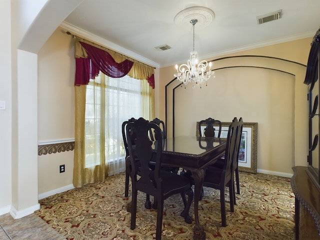 dining area featuring crown molding and a notable chandelier