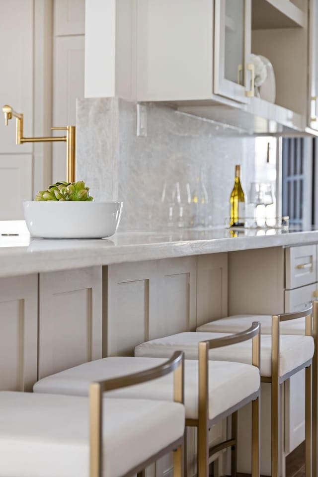 kitchen with white cabinetry and backsplash