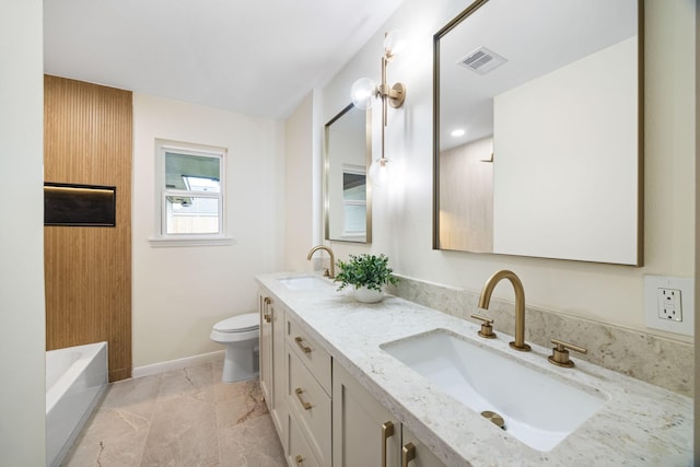 bathroom with toilet, vanity, and a bathing tub