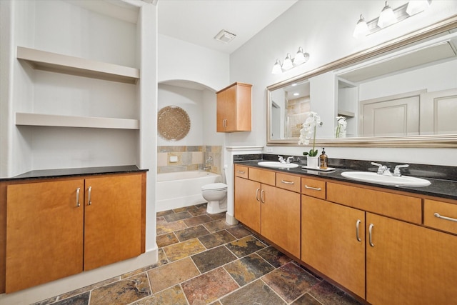 bathroom with vanity and a bath