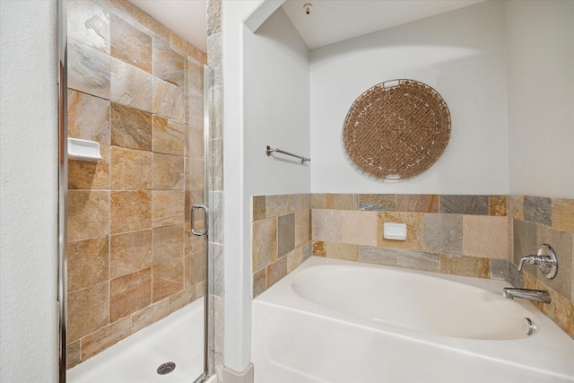 bathroom with shower with separate bathtub