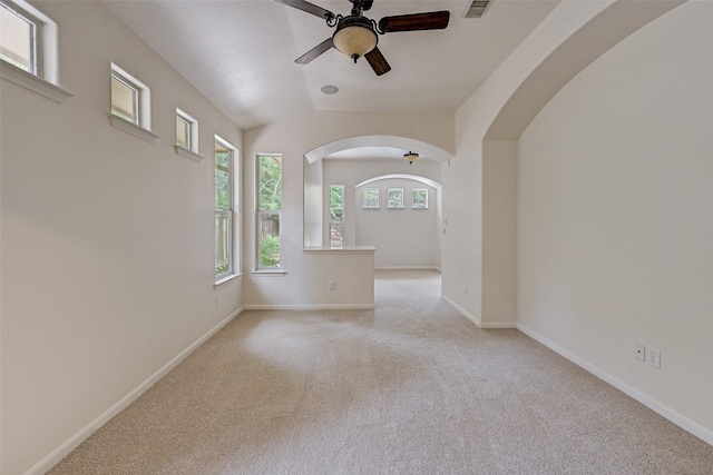 unfurnished room featuring vaulted ceiling, ceiling fan, and light colored carpet