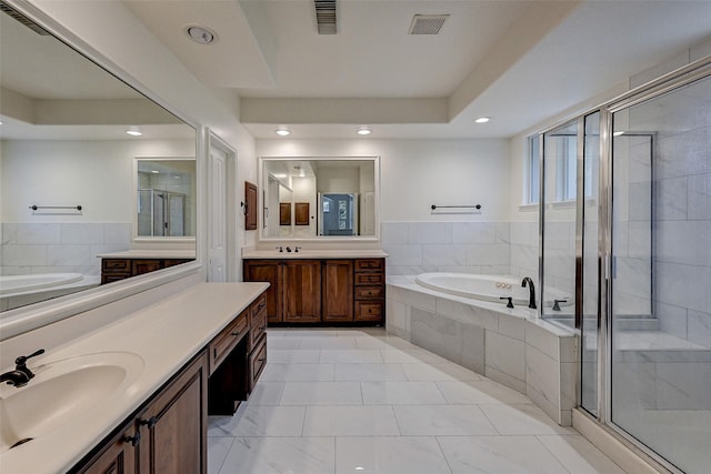 bathroom featuring separate shower and tub and vanity