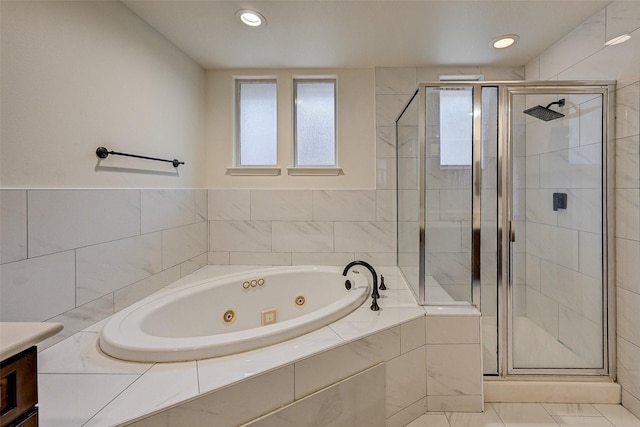 bathroom featuring vanity, independent shower and bath, and tile patterned flooring