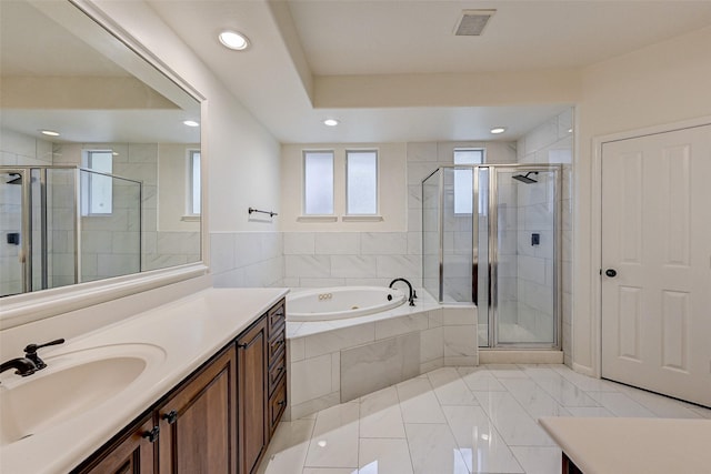 bathroom with tile patterned flooring, shower with separate bathtub, and vanity