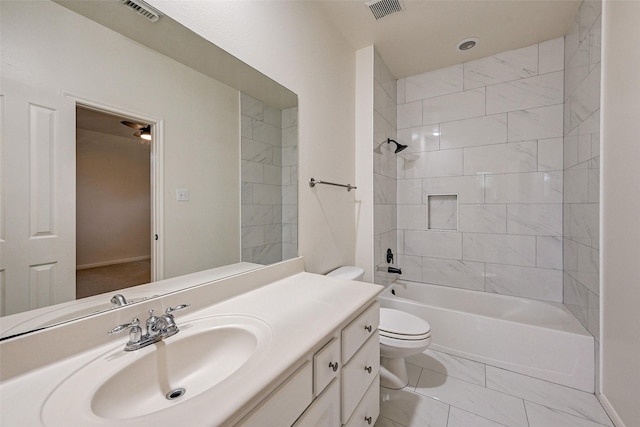 full bathroom featuring tiled shower / bath combo, vanity, and toilet