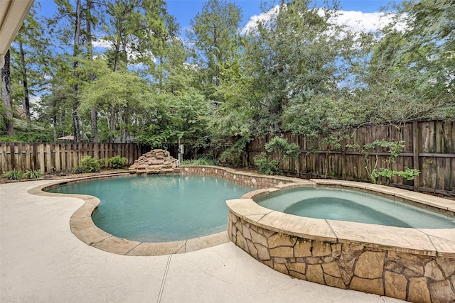 view of swimming pool featuring an in ground hot tub