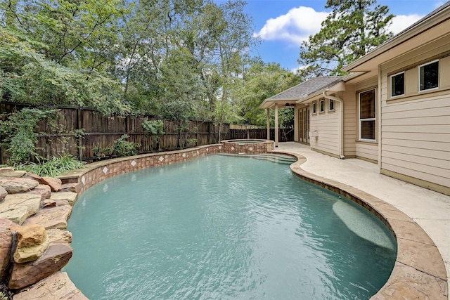 view of swimming pool featuring an in ground hot tub