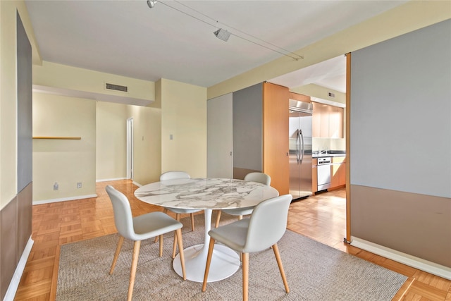 dining area featuring light parquet flooring