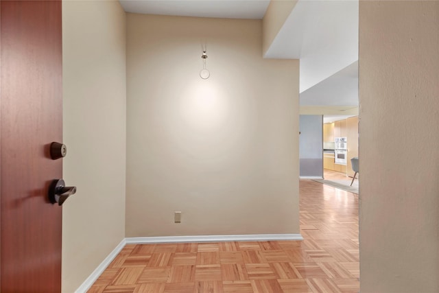 unfurnished room with light parquet flooring