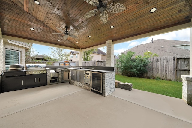 view of patio with ceiling fan, wine cooler, exterior kitchen, and area for grilling