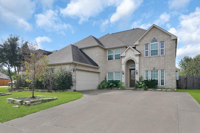 view of front of home featuring a front yard and a garage