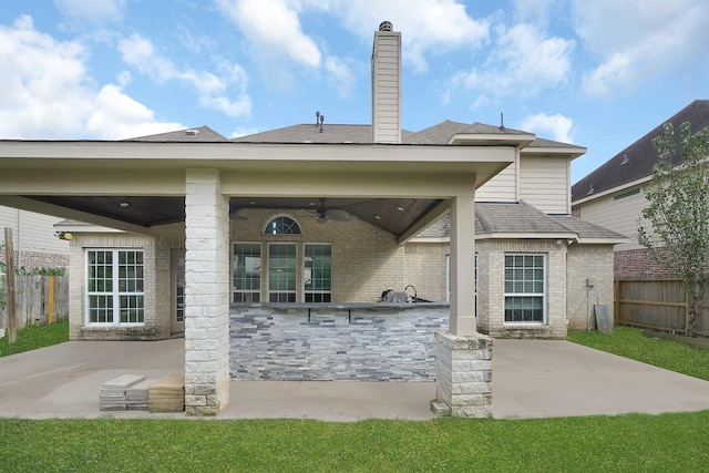 back of property featuring ceiling fan, a patio area, and area for grilling