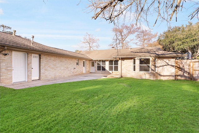 back of house featuring a yard and a patio