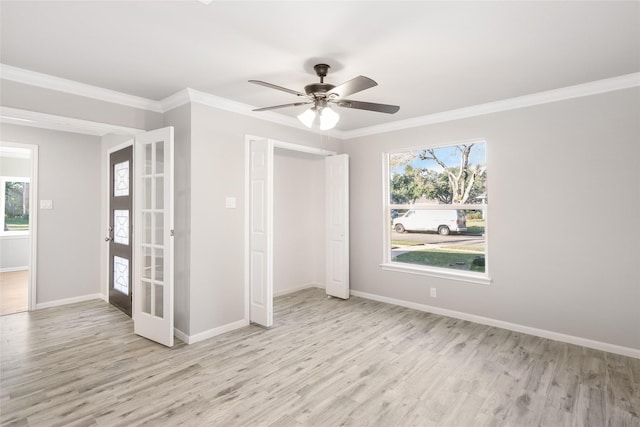 unfurnished room featuring light hardwood / wood-style floors, plenty of natural light, ceiling fan, and french doors