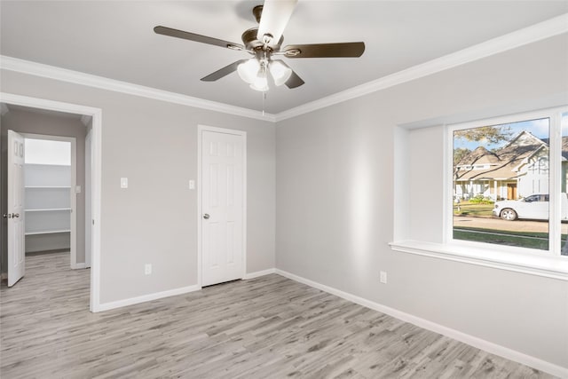 unfurnished bedroom featuring ceiling fan, crown molding, and light hardwood / wood-style flooring