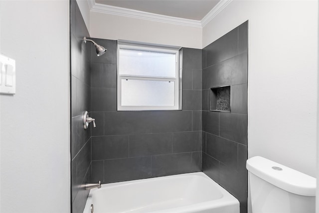 bathroom with toilet, tiled shower / bath combo, and crown molding