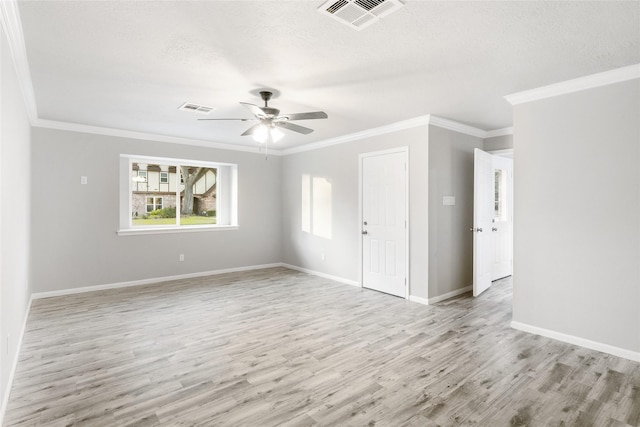 empty room with ceiling fan, crown molding, and light hardwood / wood-style flooring