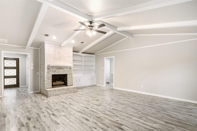 unfurnished living room featuring ceiling fan, light wood-type flooring, built in features, a fireplace, and vaulted ceiling with beams