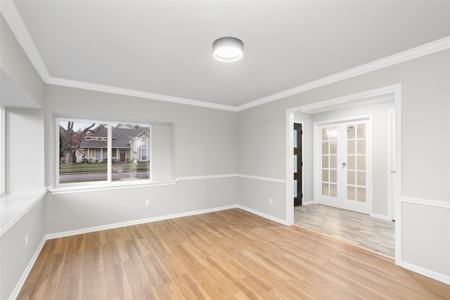 unfurnished room with wood-type flooring, french doors, and ornamental molding