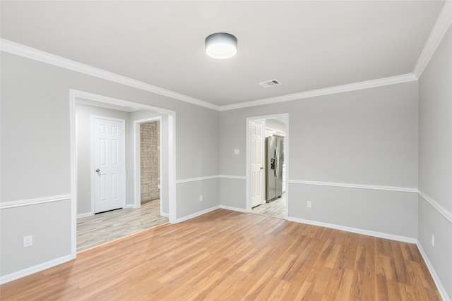 unfurnished room featuring light hardwood / wood-style flooring and ornamental molding