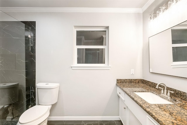 bathroom with toilet, vanity, ornamental molding, and tiled shower