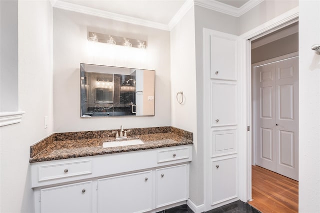 bathroom featuring wood-type flooring, vanity, and ornamental molding