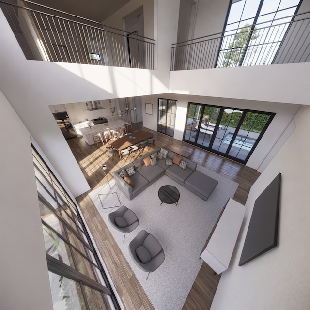 living room with a towering ceiling and plenty of natural light