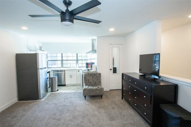 living area with ceiling fan and light carpet