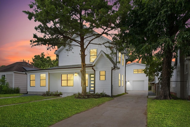 view of front facade with a garage and a lawn