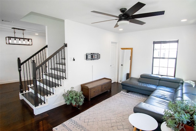 living room with dark wood-type flooring and ceiling fan