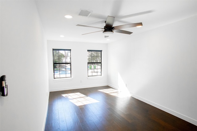 empty room featuring ceiling fan and dark hardwood / wood-style flooring