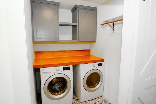 washroom featuring cabinets, washer and dryer, and light tile patterned floors