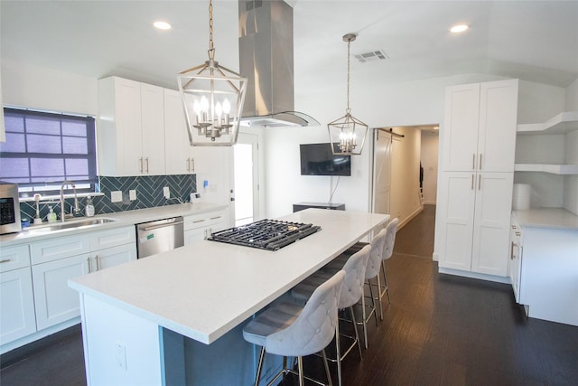 kitchen with sink, appliances with stainless steel finishes, a center island, white cabinets, and island exhaust hood