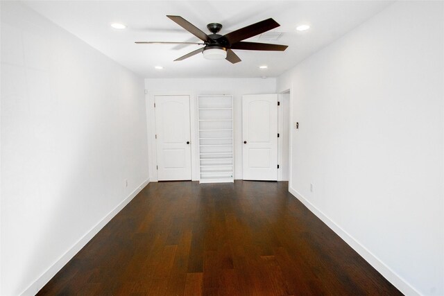 unfurnished bedroom featuring dark hardwood / wood-style flooring and ceiling fan