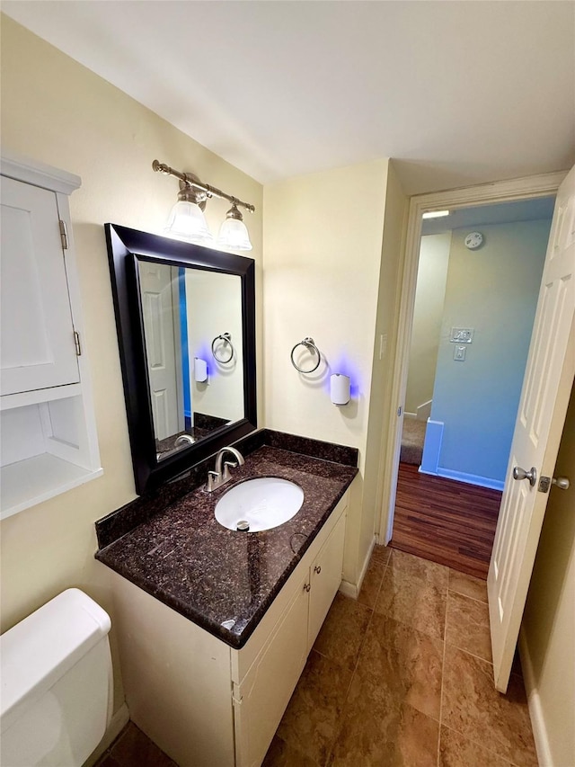 bathroom featuring vanity and toilet