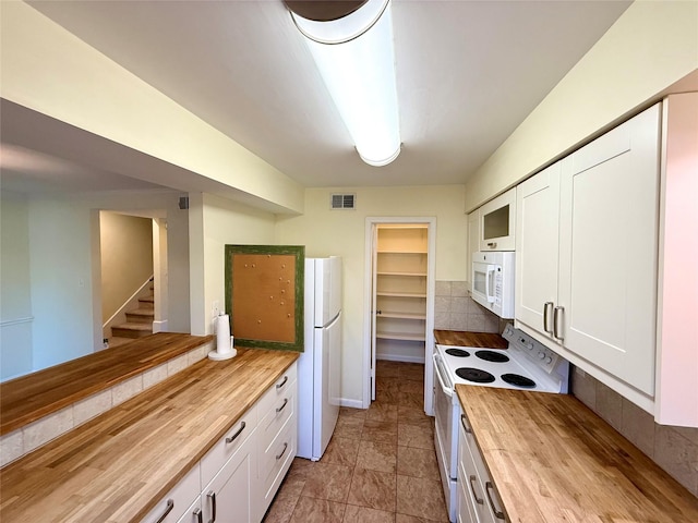 kitchen with white cabinetry, white appliances, wooden counters, and backsplash