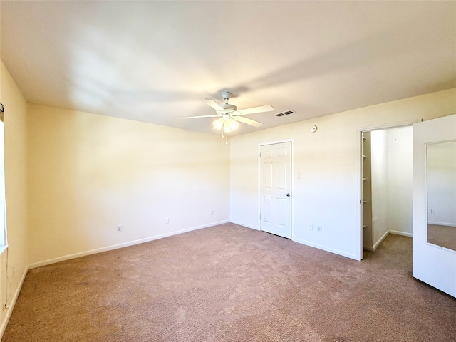 unfurnished bedroom featuring ceiling fan and carpet flooring