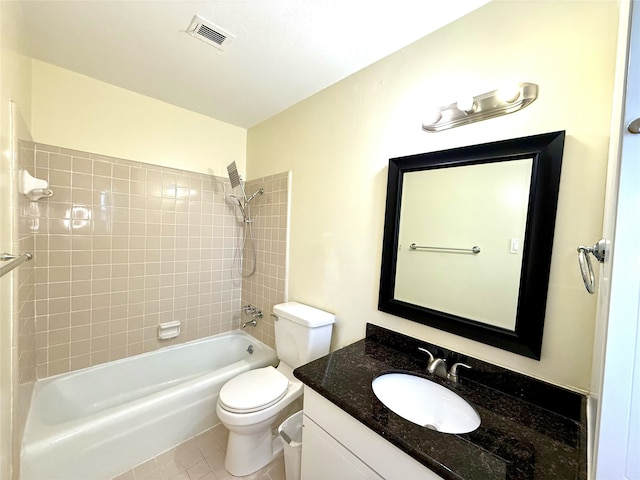 full bathroom featuring vanity, tile patterned floors, toilet, and tiled shower / bath