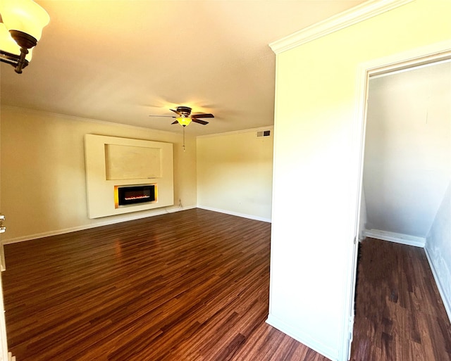 unfurnished living room featuring ornamental molding, dark hardwood / wood-style flooring, and ceiling fan