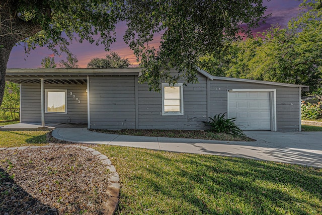 ranch-style house featuring a yard and a garage