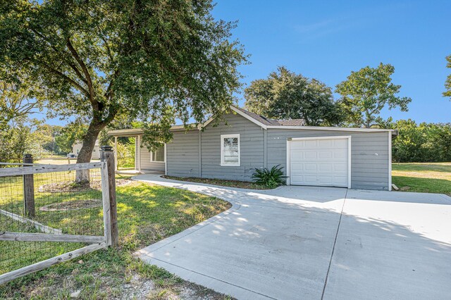 single story home with a front yard and a garage