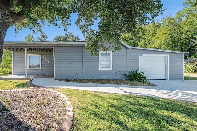 ranch-style home with a garage and a front yard