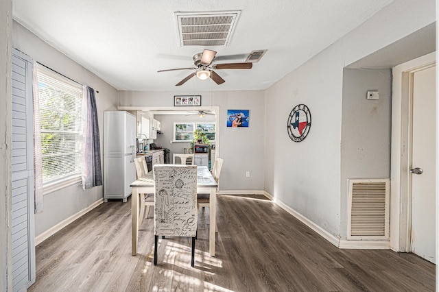 dining area with ceiling fan and hardwood / wood-style floors