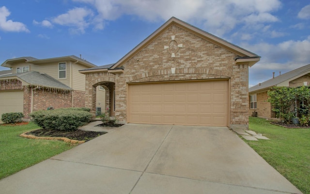 view of front of property featuring a front lawn and a garage