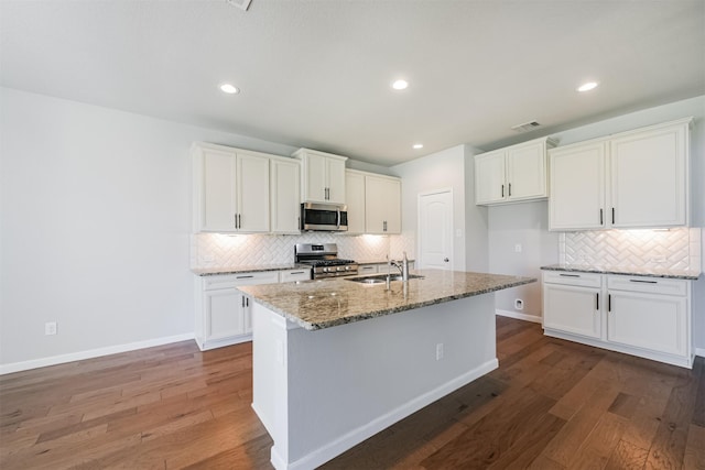 kitchen with stainless steel appliances, sink, and white cabinets