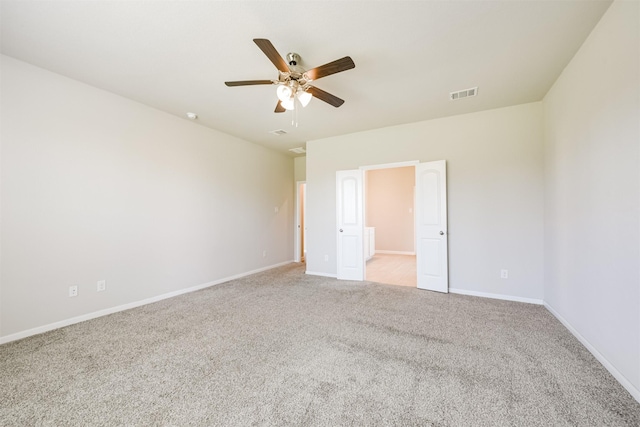 unfurnished bedroom with ceiling fan, connected bathroom, and light carpet