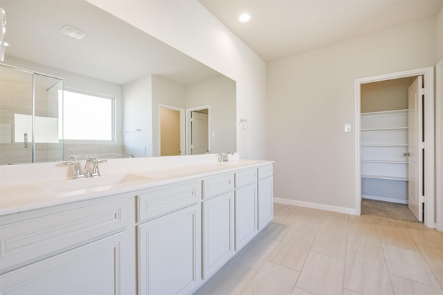 bathroom with vanity and a shower with shower door