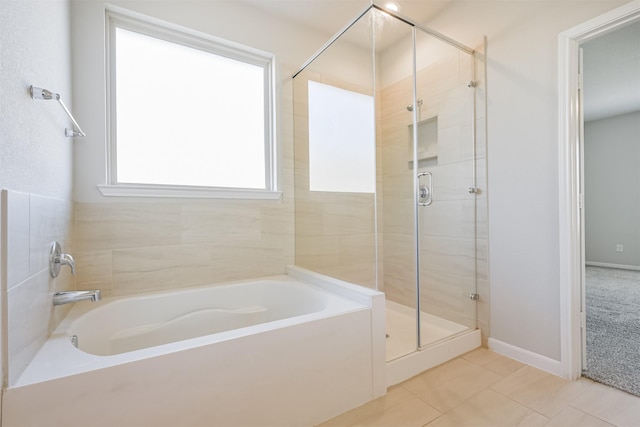 bathroom featuring independent shower and bath and tile patterned flooring